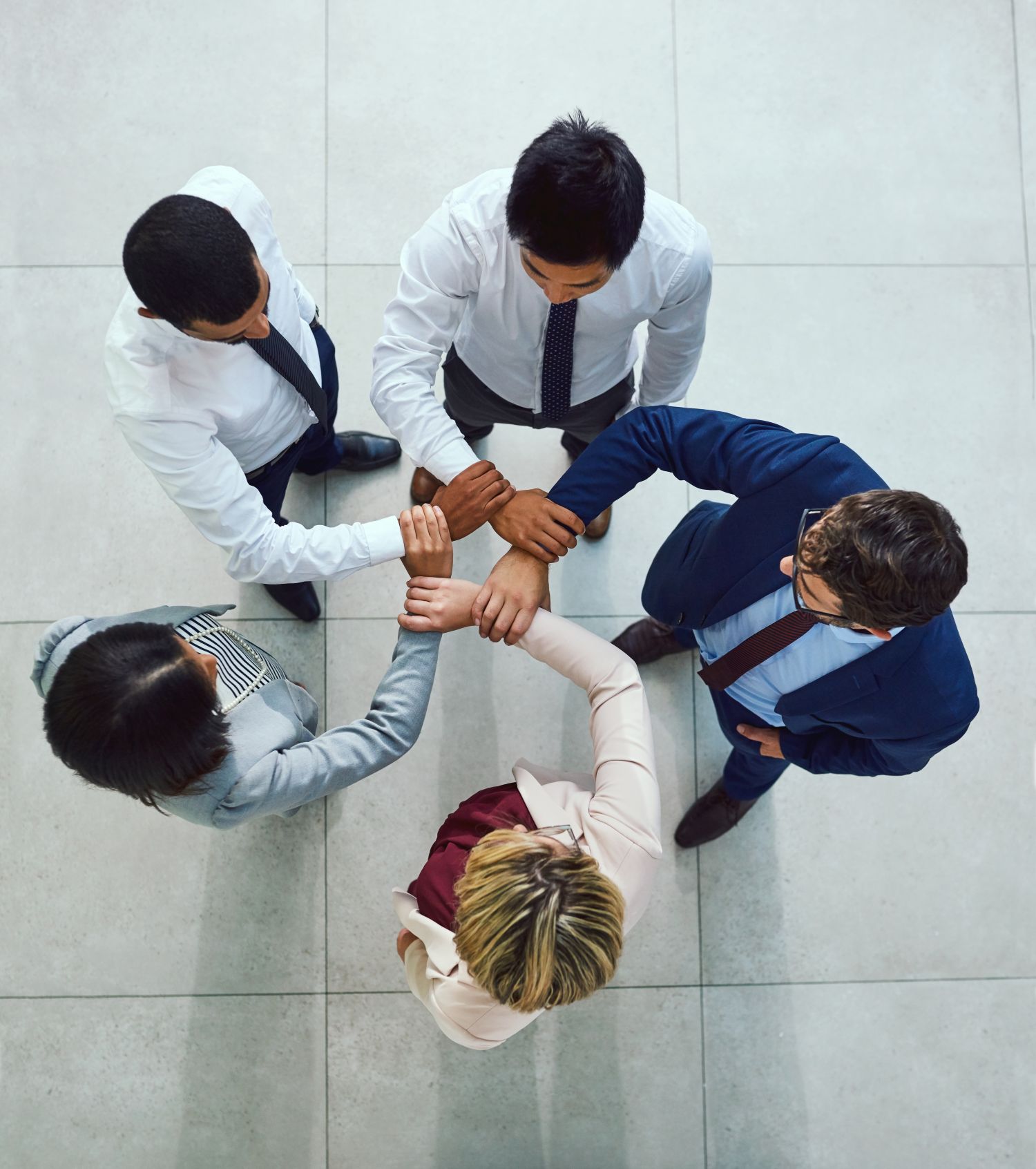 people in circle handing hands